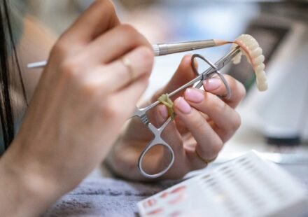 Dental technician working on a prosthetic denture in a dental laboratory