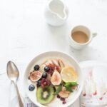 Healthy breakfast bowl with fresh berries and coffee for a busy morning